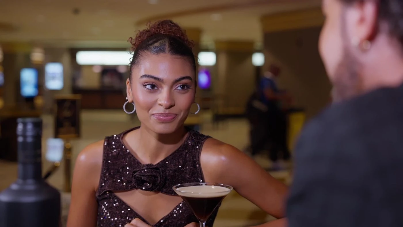 Live-action version: the actress holds her espresso martini during the closing exchange